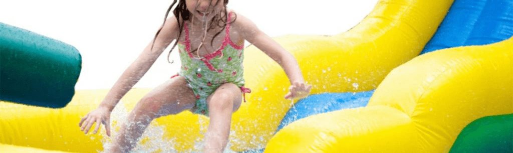 Child playing on inflatable water slide